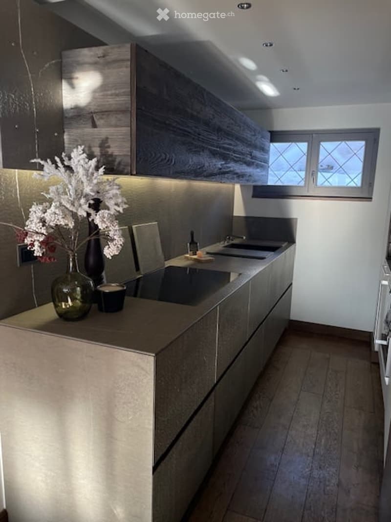 modern kitchen with wooden floor, double sink, cabinets, stainless steel counters, windows