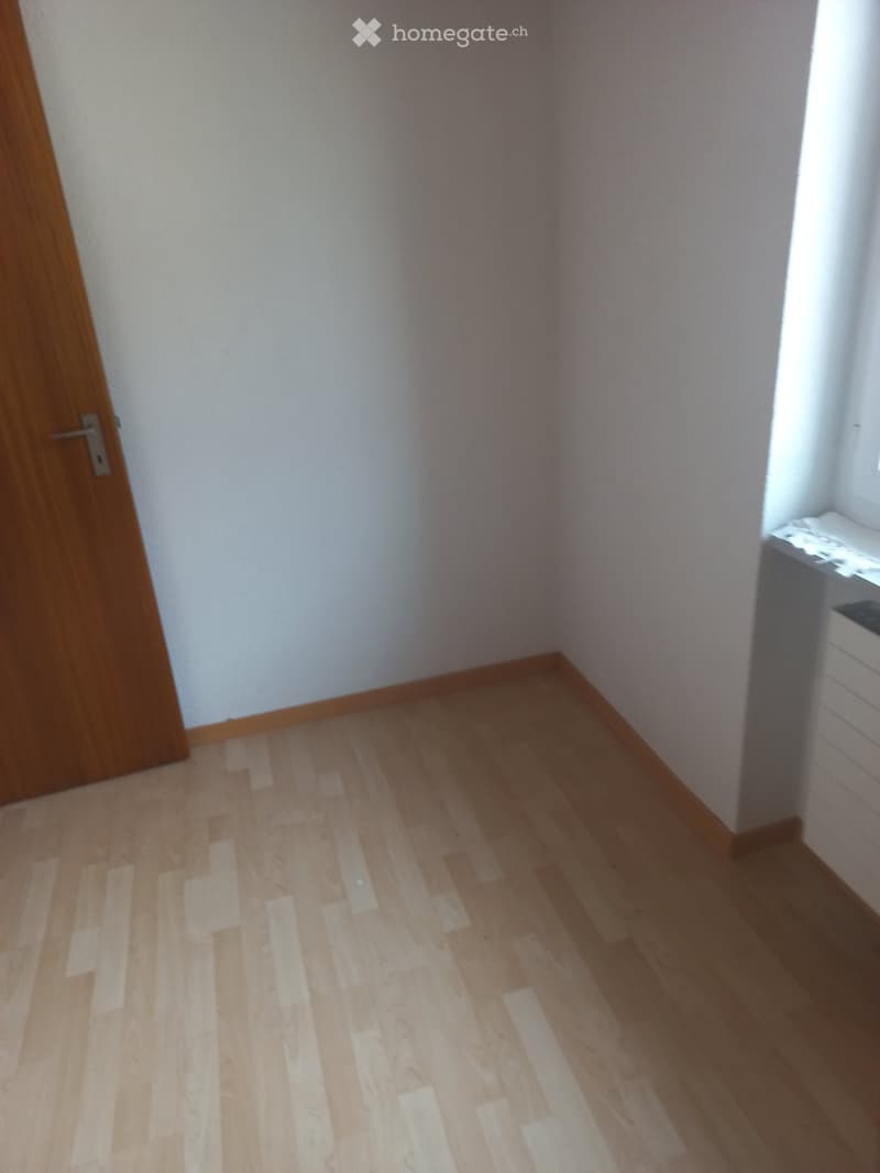 Empty room with wooden floor and white walls