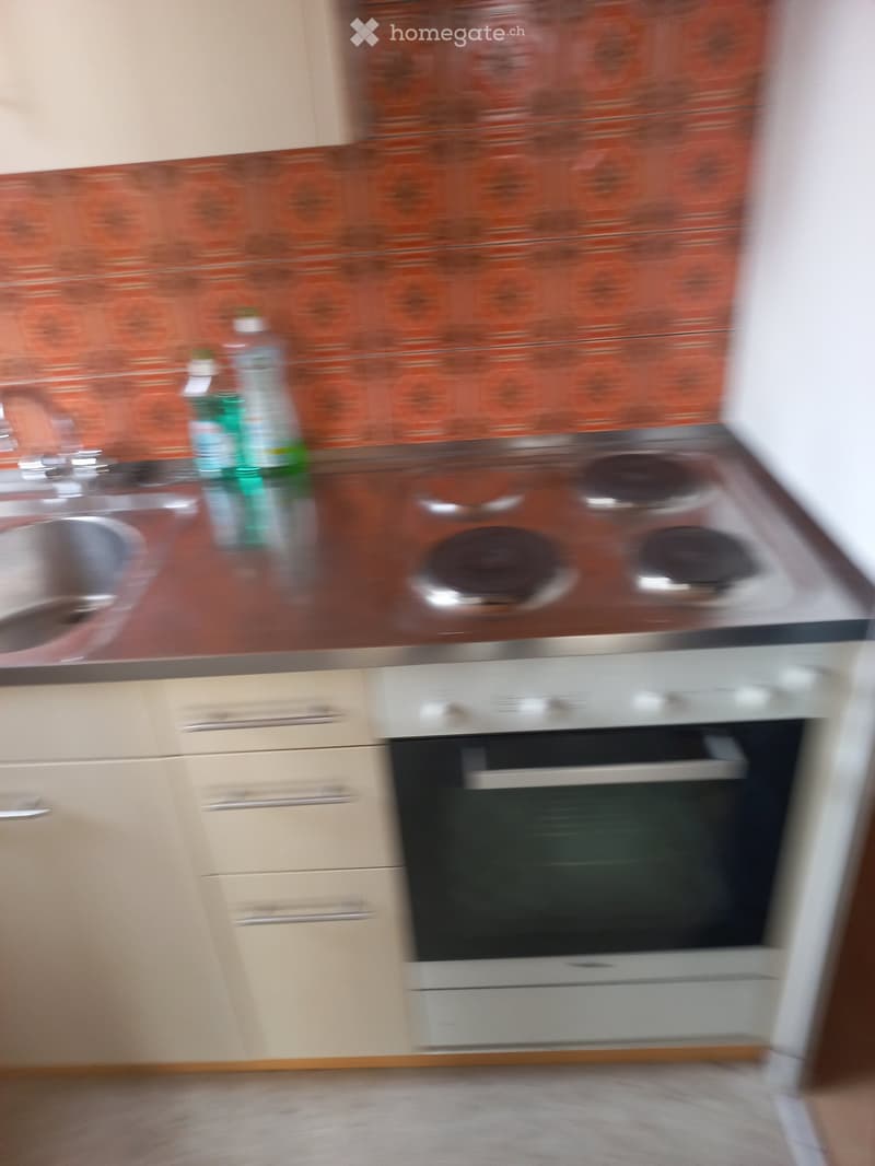 kitchen with wooden cabinets, stainless steel countertop, gas stove, sink, oven