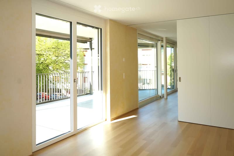 large sliding glass doors, wooden floor, yellow wall, balcony