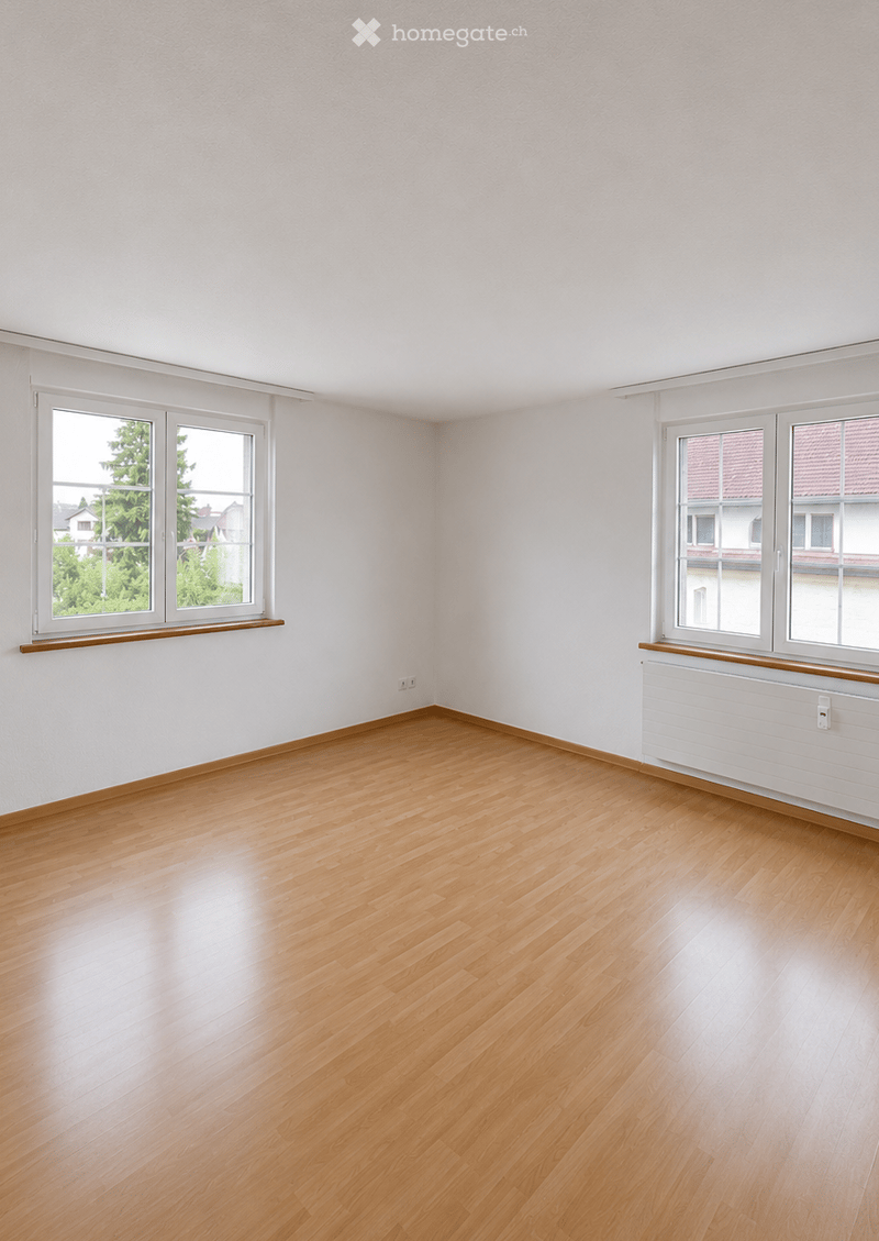 Empty room with light wooden flooring, white walls, and large windows with wooden sills. No furniture or equipment present.