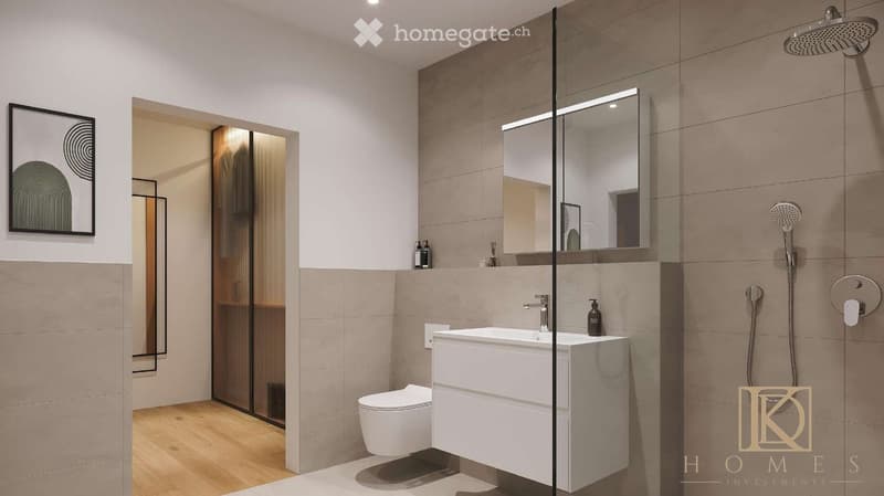 Modern bathroom with a white sink, toilet, large mirror, and glass-enclosed shower area. Beige tiles and wooden flooring.