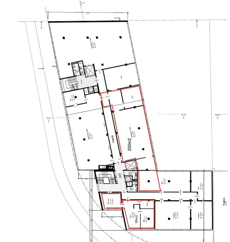 Floor plan of a building with multiple rooms, including a large open space, smaller rooms, and a hallway.