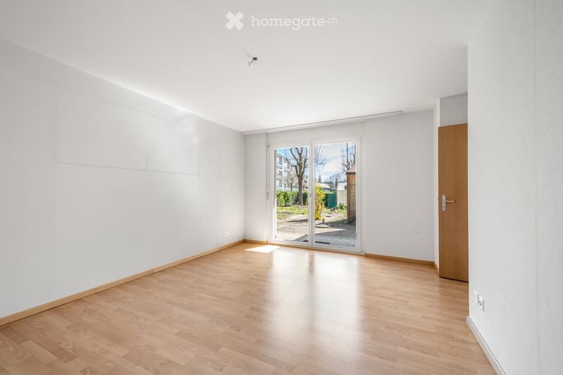 Completely empty room with bare white walls and wooden floor. No furniture or equipment.