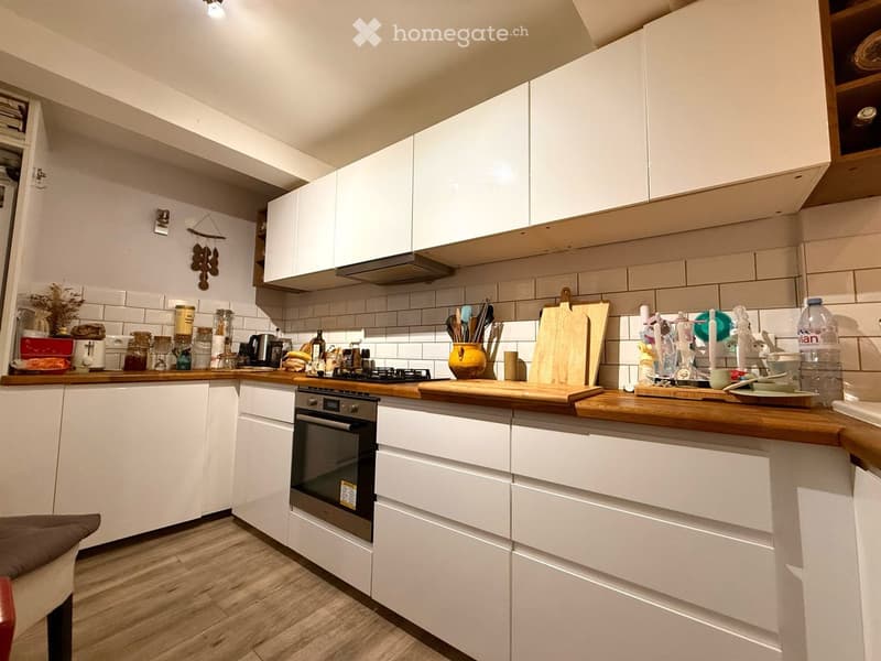 {"type": "Kitchen", "objects": ["oven", "cabinets", "countertop", "cutting board", "kitchen utensils", "faucet", "bottle", "bowl", "cup", "jar", "bowl", "bottle", "cup", "cup", "cup", "cup", "cup", "cup", "cup", "cup", "cup", "cup", "cup", "cup", "cup", "