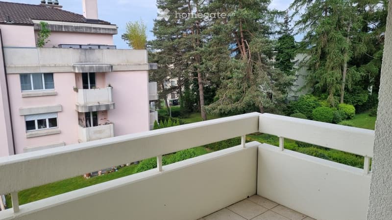 White railings, tiled floor, garden and tree views