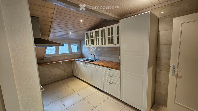 Kitchen with white cabinets, wooden countertop, tiled floor, tiled backsplash, gas stove, stainless steel sink, large window