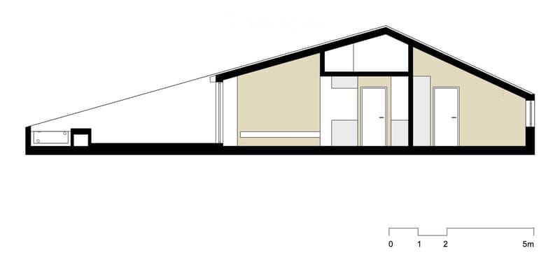 Floor plan of a single-story house with a pitched roof, featuring a garage, entrance door, and multiple rooms.