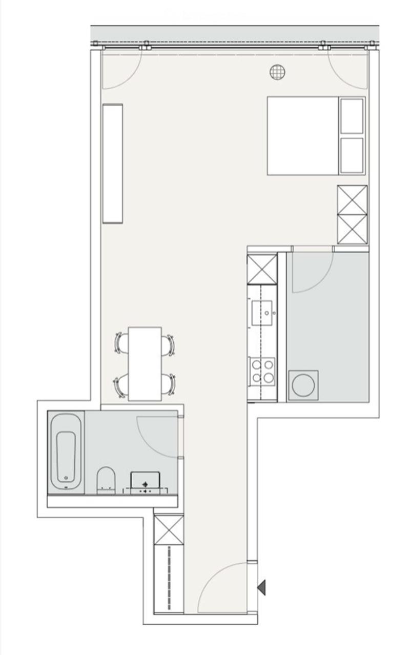 Layout of a compact studio apartment featuring a combined living and sleeping area, a kitchenette, and a bathroom.