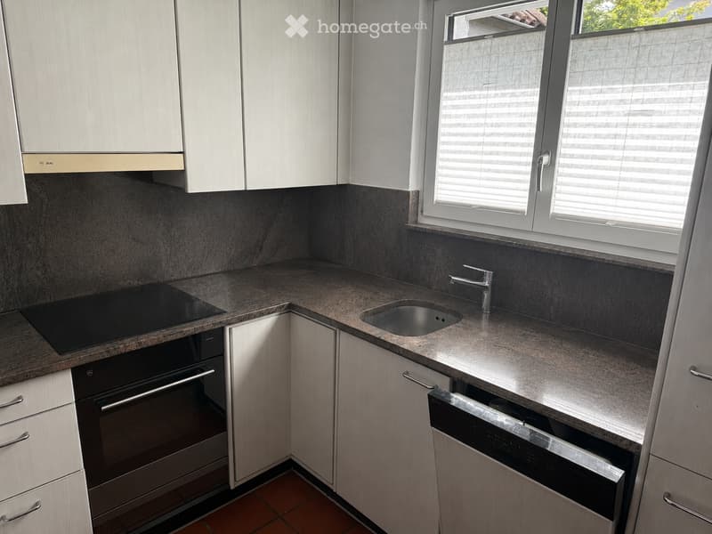 Kitchen. Modern kitchen with granite countertops, stainless steel appliances, and white cabinets.