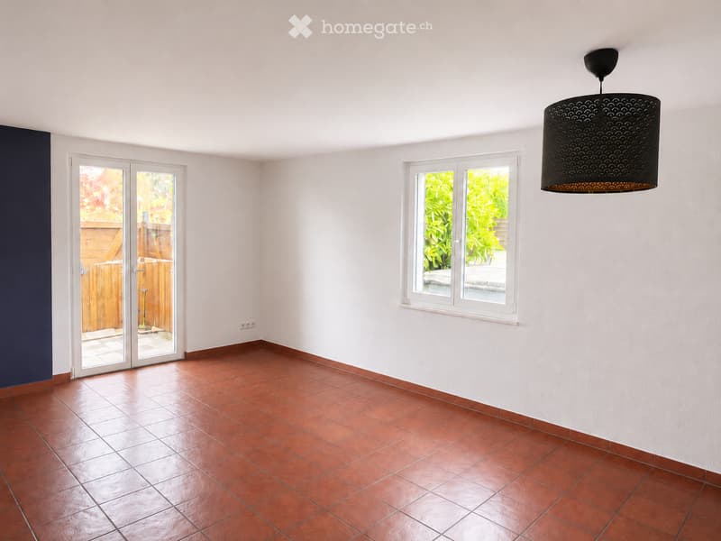 Unfurnished Room. Empty room with red tiled floor, white walls, large window, and sliding glass door leading to outdoor area.