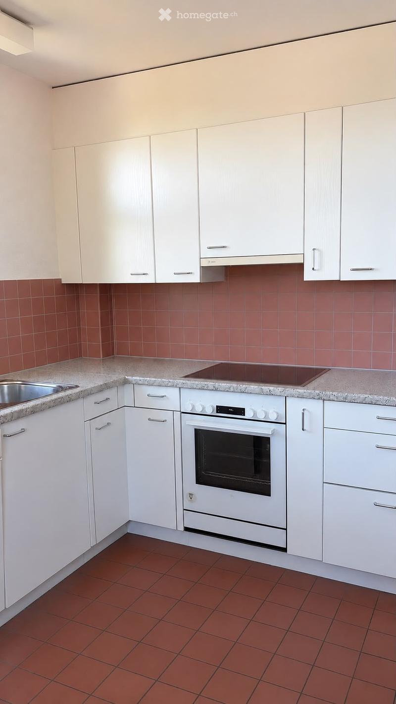 Modern kitchen with white cabinets, granite countertops, red tiled backsplash, and a built-in oven.