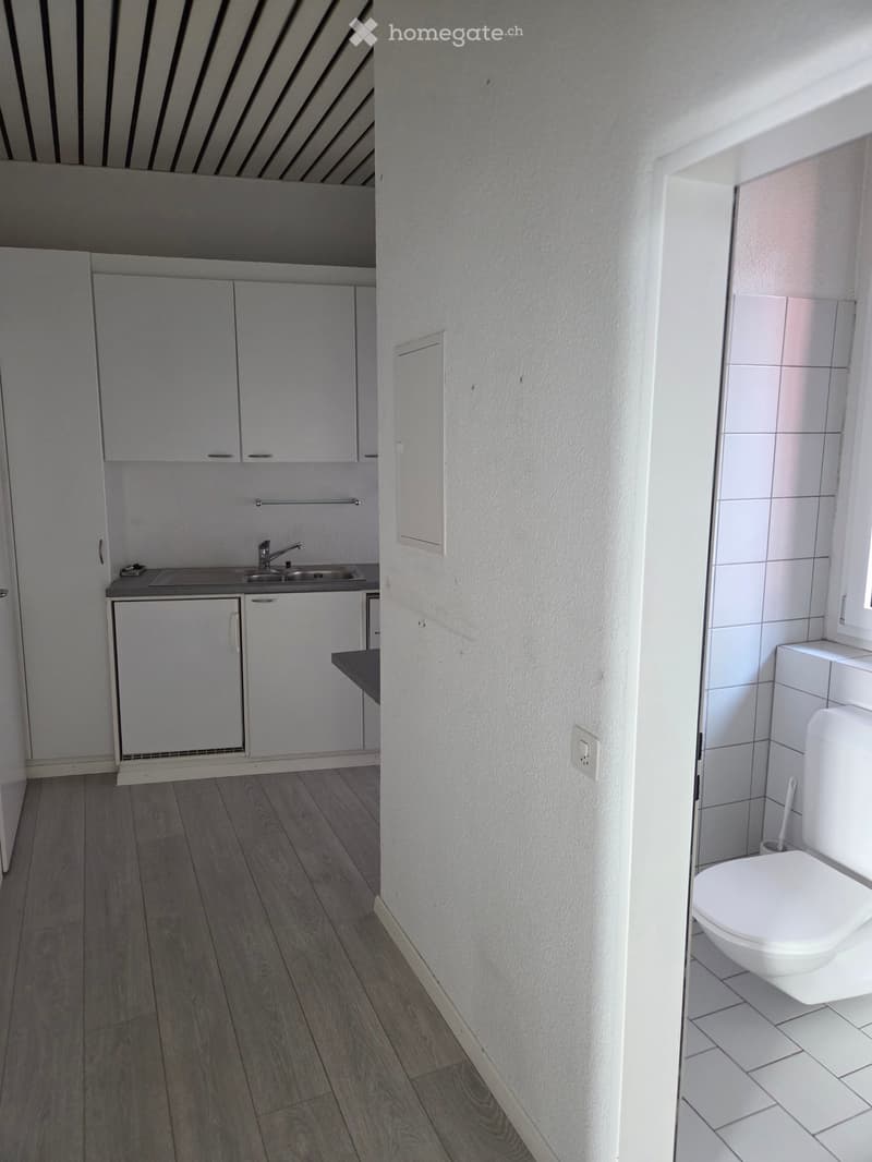 small kitchen with sink, cabinets, and a dishwasher