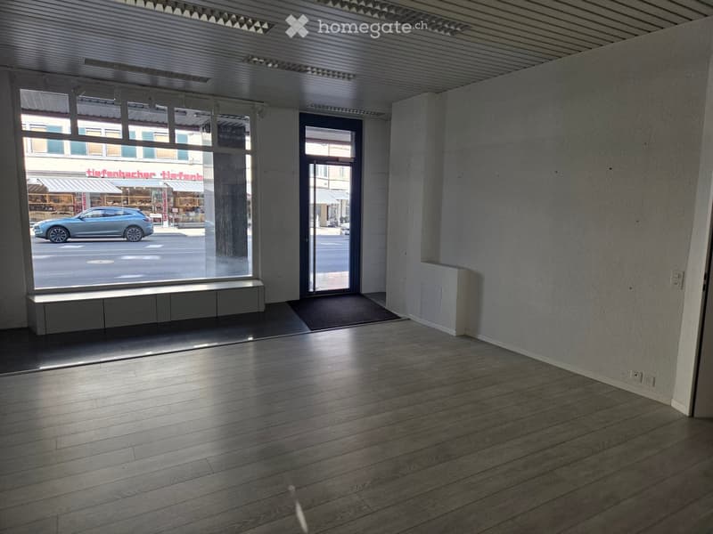 empty room, large windows, wooden floor, white walls, door, power outlets