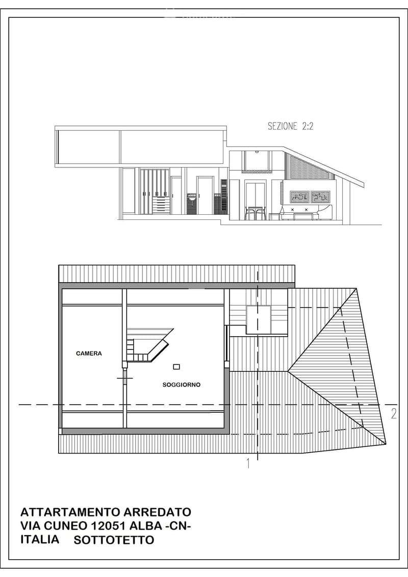 Floor plan of a furnished apartment with living room, bedroom, and staircase leading to an upper level.