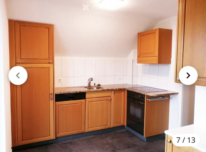Modern kitchen with wooden cabinets, granite countertops, sink, faucet, oven, and dishwasher.