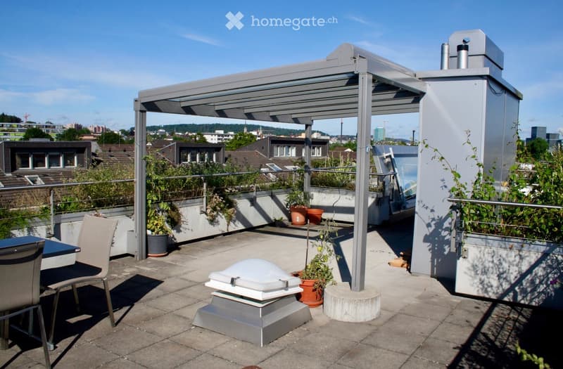 Roof terrace with a covered seating area, potted plants, and a cityscape view.