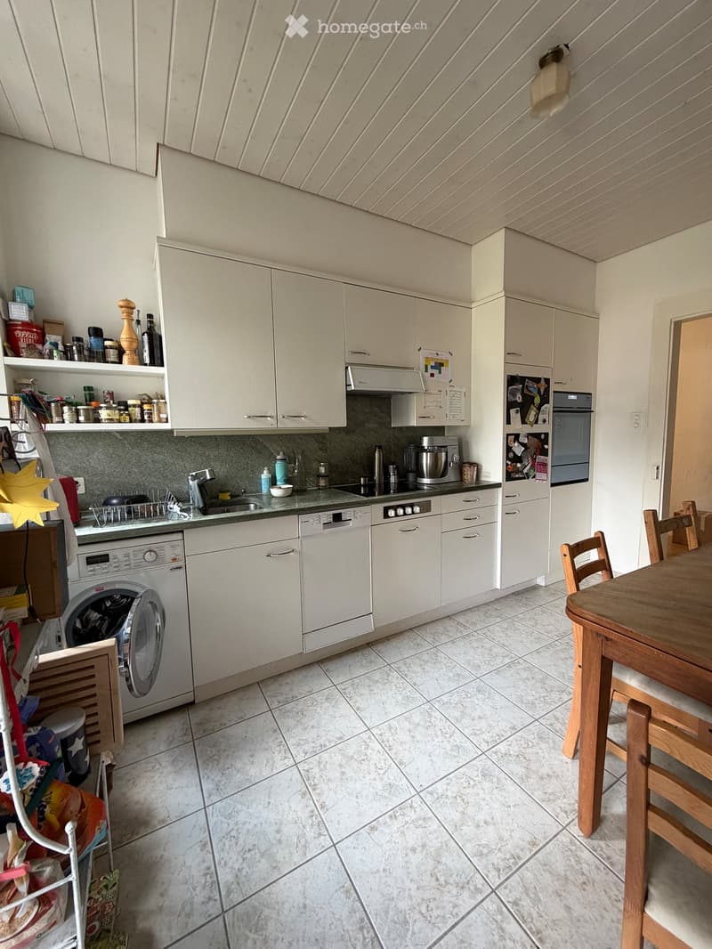 {"type": "Kitchen", "objects": ["table", "chair", "refrigerator", "oven", "dishwasher", "washing machine", "sink", "faucet", "cupboard", "bottle", "bowl", "fridge", "oven", "cupboard", "faucet", "sink", "cupboard", "cupboard", "cupboard", "cupboard", "cup