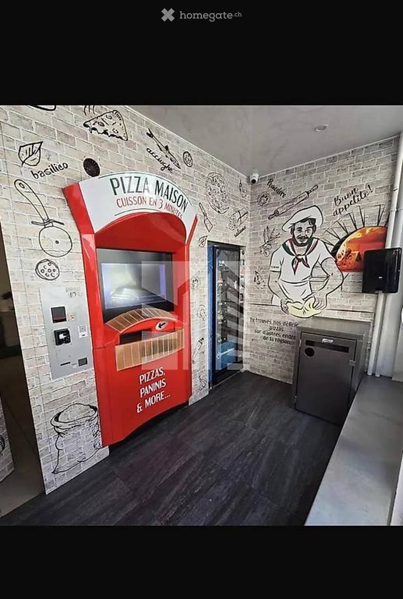 The room features a pizza vending machine with a screen and cash slot, a waste bin, and a brick wall mural with pizza and chef illustrations.