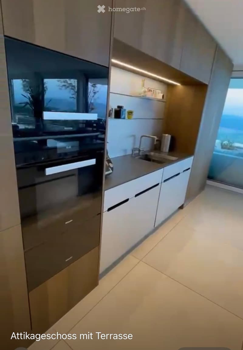 Modern kitchen with white cabinets, stainless steel oven, and a sink with a faucet.