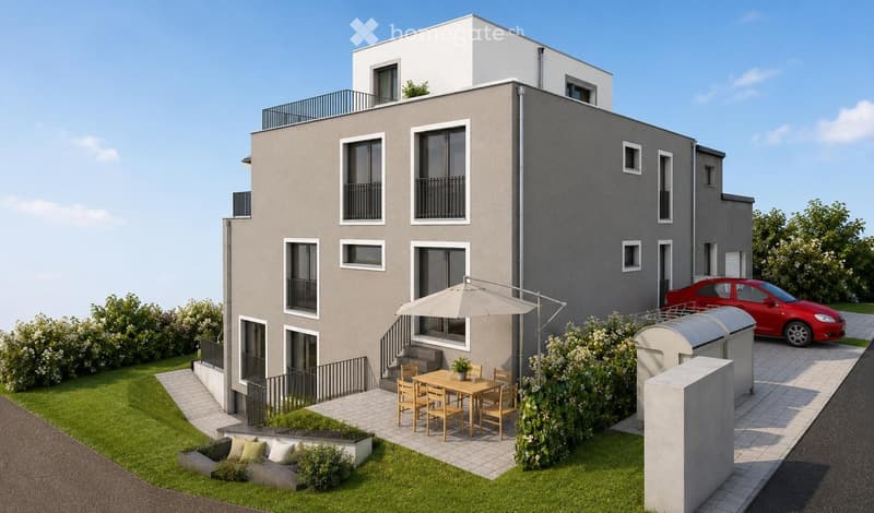 Modern two-story house with grey facade, multiple windows, balconies, and a well-maintained garden area with outdoor furniture and a parked car.