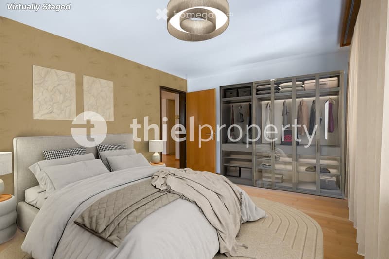 Modern bedroom with a large bed, nightstands, a wardrobe with mirrored doors, and artwork on the wall.