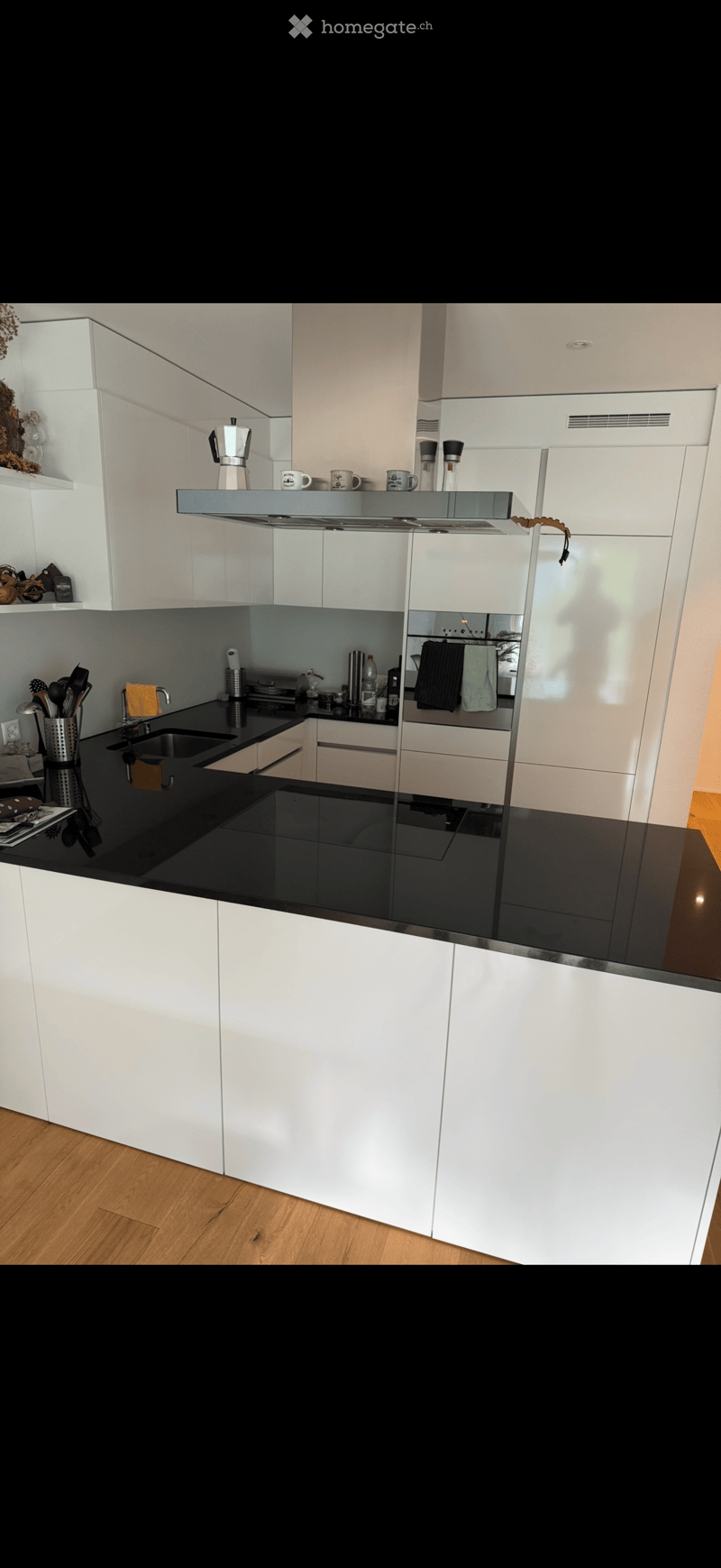 {"type": "Kitchen", "objects": ["coffee maker", "cup", "faucet", "sink", "oven", "cabinets", "kitchen island", "cupboard", "fridge", "oven", "cupboard", "cupboard", "cupboard", "cupboard", "cupboard", "cupboard", "cupboard", "cupboard", "cupboard", "cupbo
