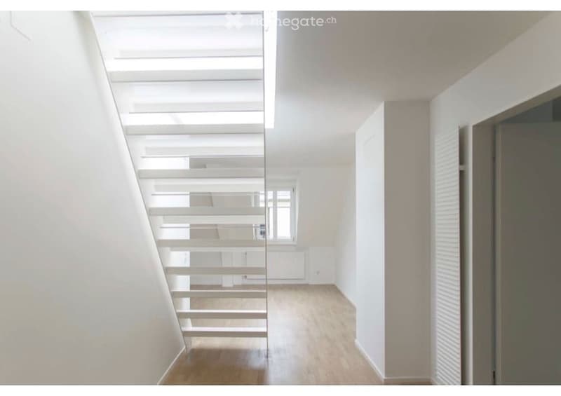 Completely empty room with bare walls and wooden floor. No furniture or equipment.