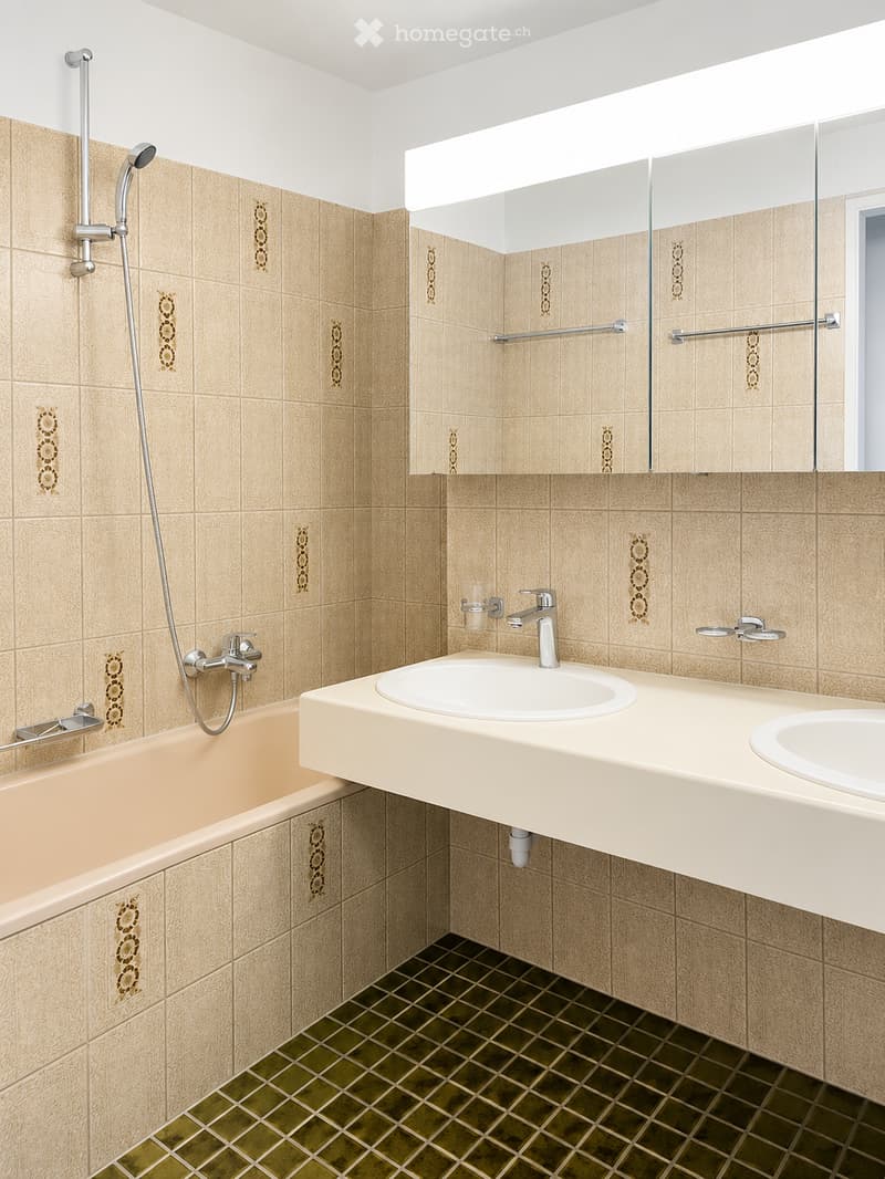 Modern bathroom with beige tiles, a bathtub, a double sink vanity, a large mirror, and a showerhead.