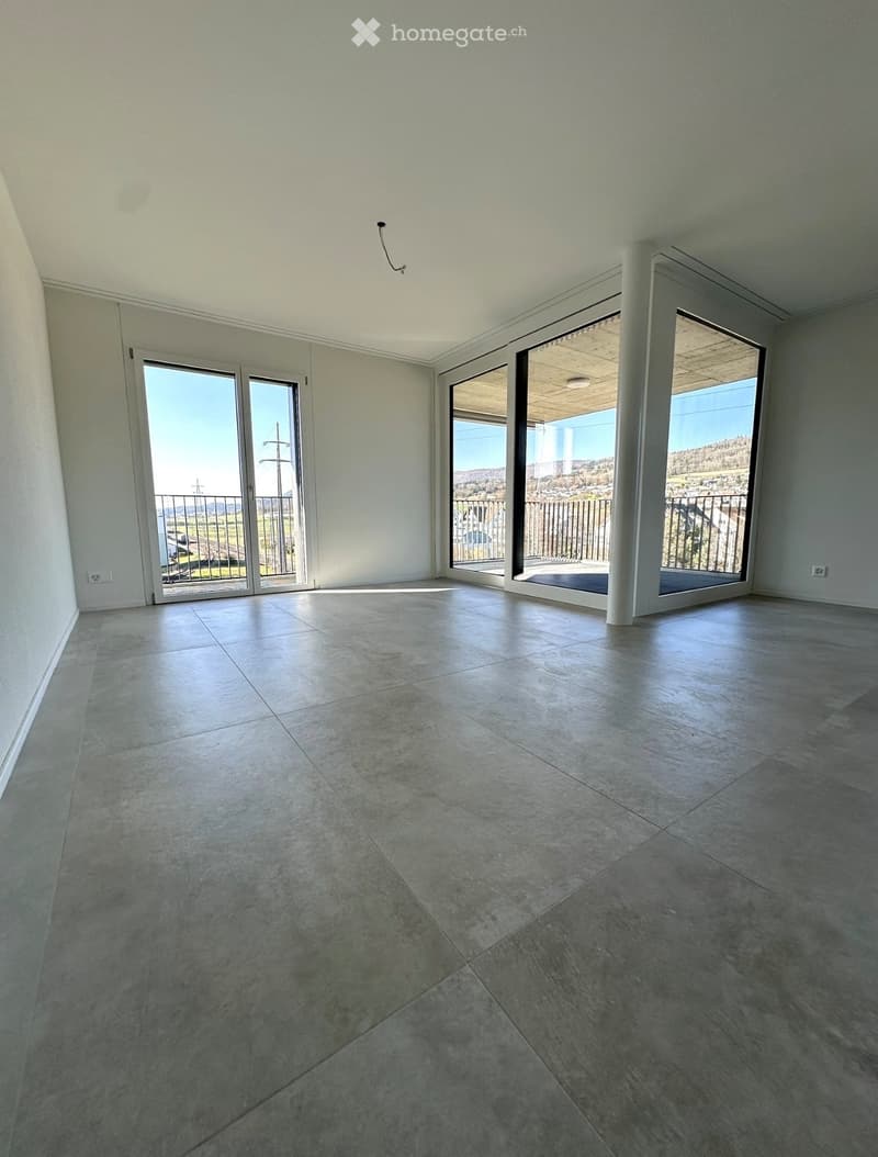 Empty room with large sliding glass doors leading to a balcony, tiled floor, and white walls.