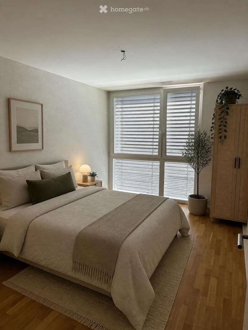 Modern bedroom with a large bed, nightstand, lamp, picture frame, wardrobe, and potted plants. The room features wooden flooring and large windows with blinds.