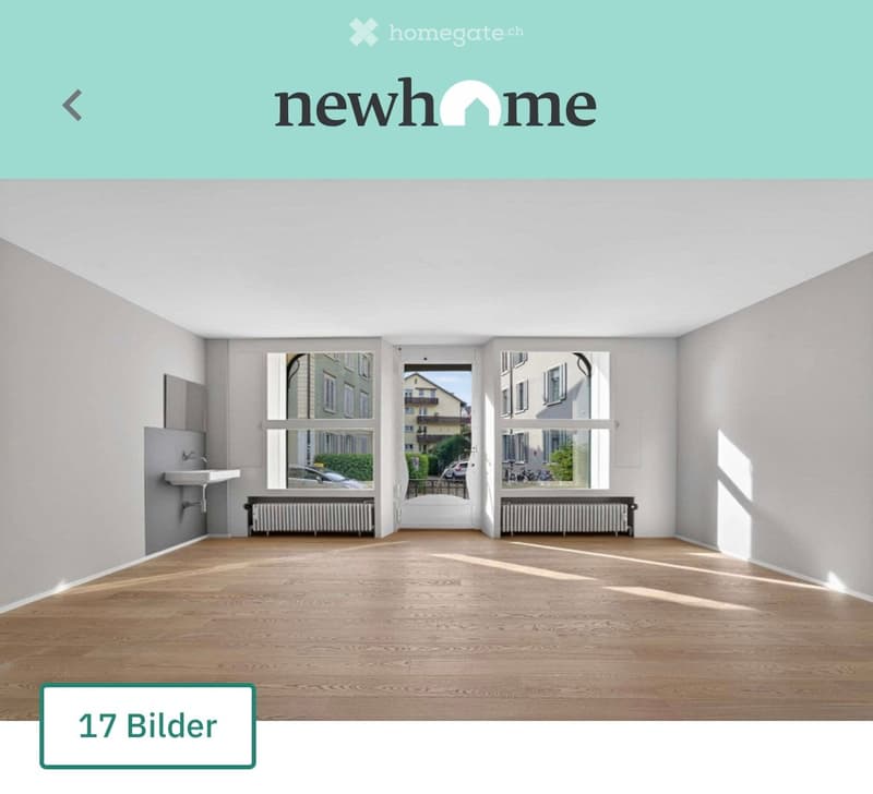 Empty room with wooden flooring, large windows, radiator, and a small sink in the corner.