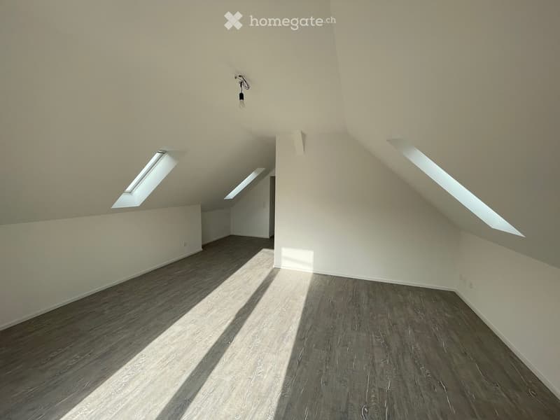 empty room, wooden floors, white walls, three attic windows, no furniture