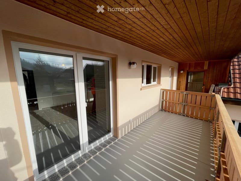 Wooden ceiling, wooden railing, double sliding doors, small light fixture