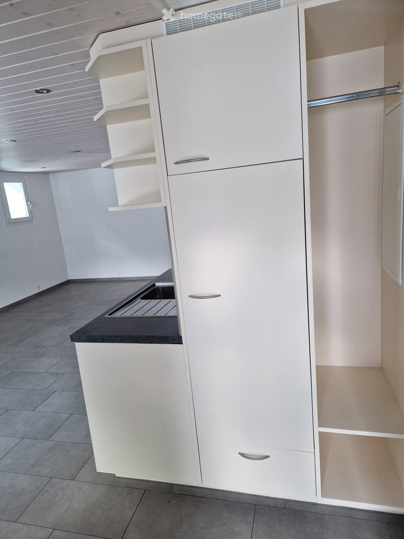 White cabinetry, countertop, tiled floor, window