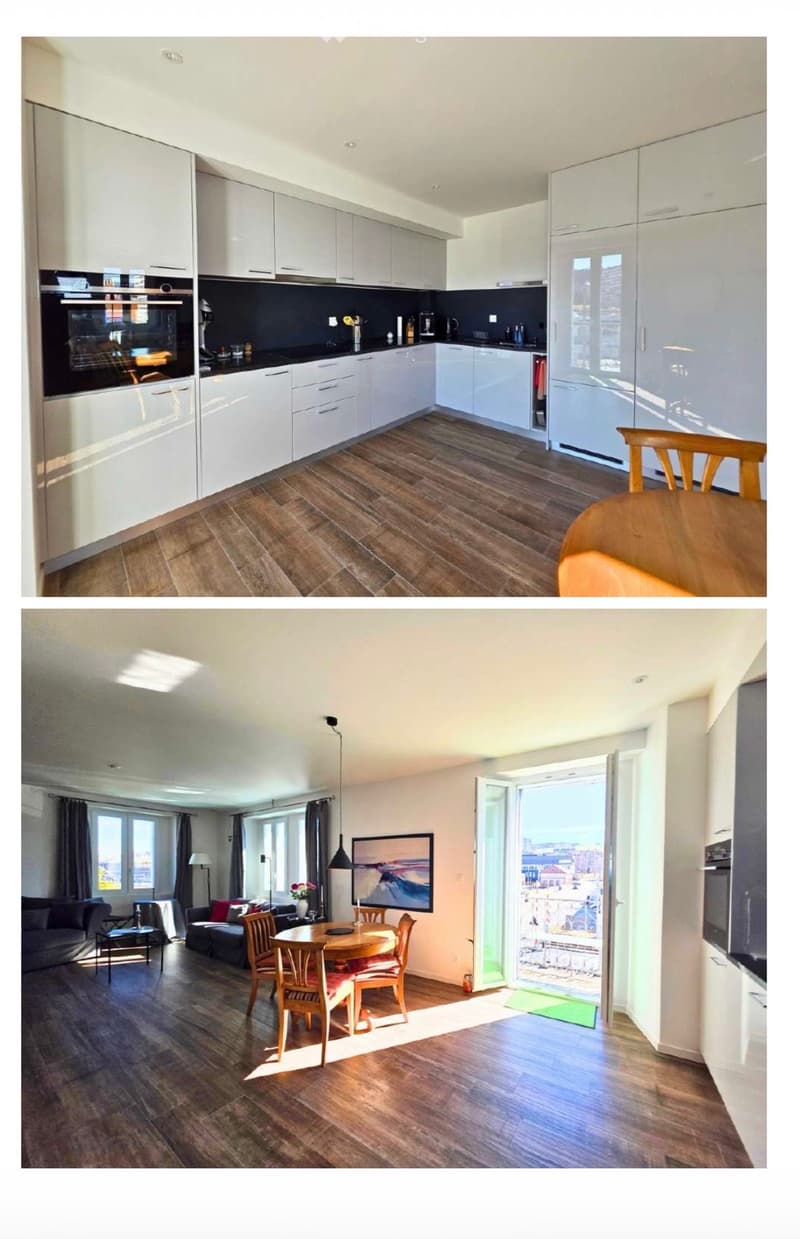 Modern kitchen with white cabinetry, black countertops, and stainless steel appliances. Adjacent living area features a dining table, chairs, sofa, and large windows with city views.