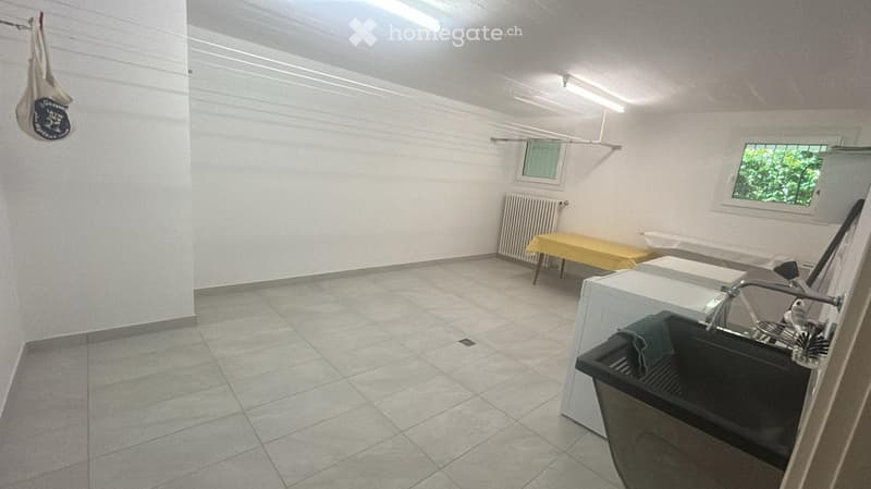 Bathroom with tiled floor, white walls, a sink with a faucet, a radiator, and a yellow bench.