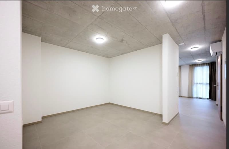 Empty room with white walls, tiled floor, and recessed lighting. No furniture or equipment present.