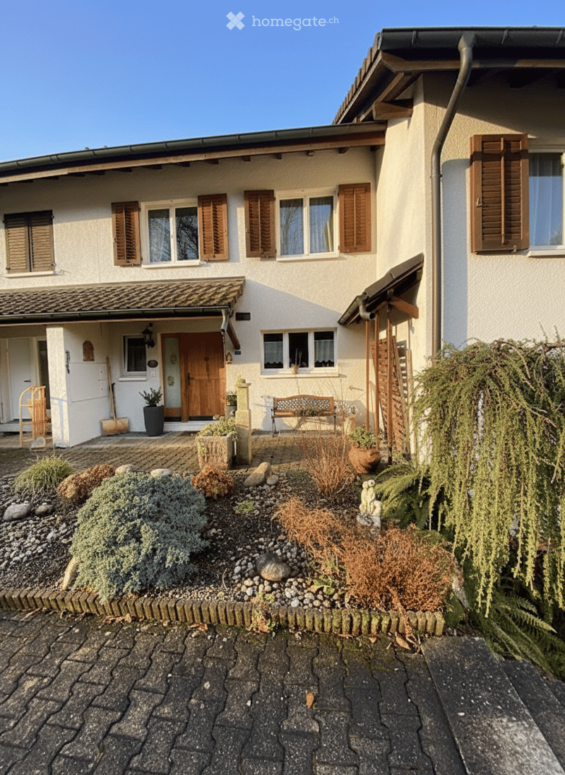 2 story house, white facade, brown wooden door, wooden shutters, multiple windows, wooden benches, garden, shrubs