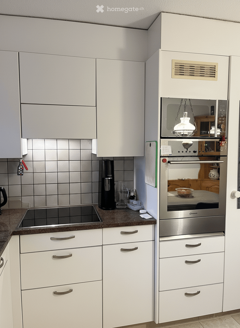 white kitchen, stainless steel oven and microwave, dishwasher, granite countertop, black stovetop, kitchen cabinets