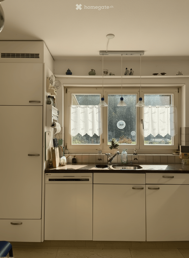 modern white kitchen, granite counter, dishwasher, washing machine, double sink, faucet, hanging cabinets, pendant lights, window with lace curtains