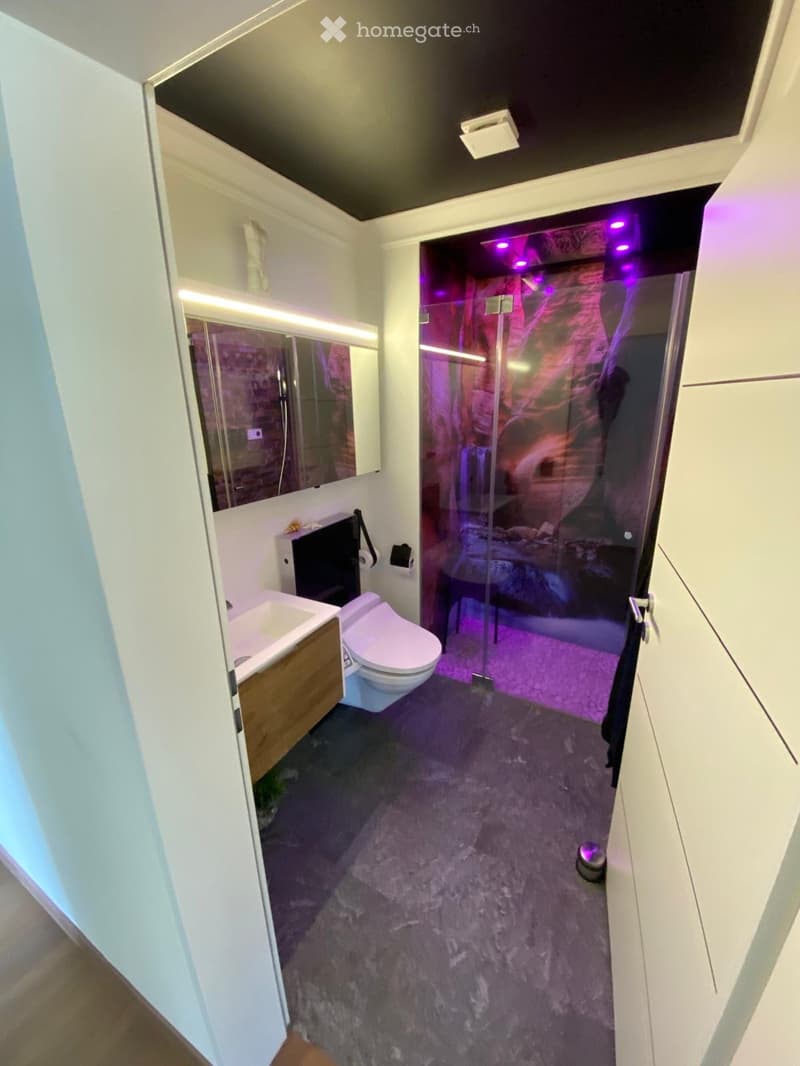 modern bathroom with shower and sink, led lights, white and gray tones