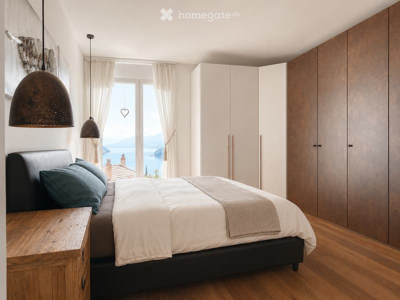 Modern bedroom with a large window offering a scenic view, featuring a black leather bed, wooden nightstand, and contemporary pendant lights.