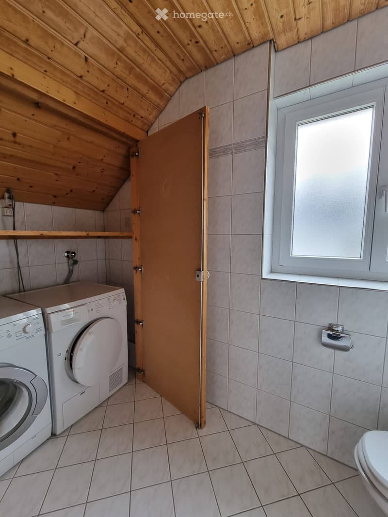 wooden ceiling, tile floor, white appliances, washing machine and dryer, white shower walls and floor, window