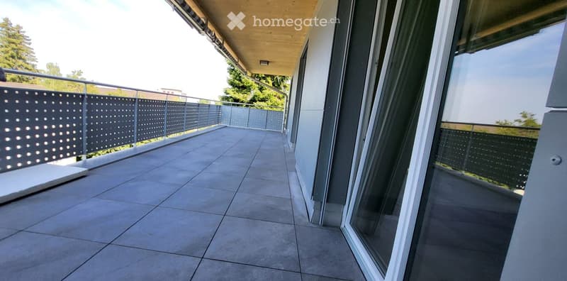 Balcony with tiled floor, metal railing, glass doors, metal ceiling
