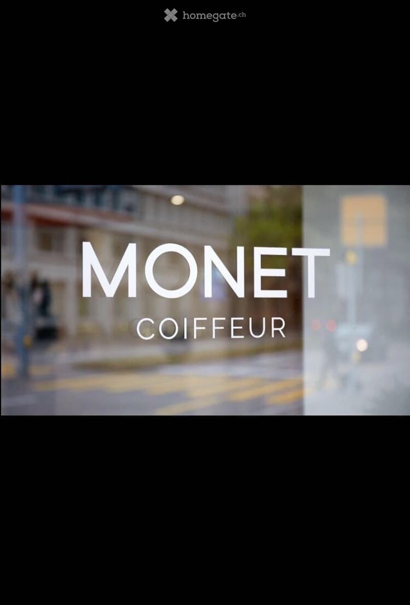 Blurred image with text overlay reading "MONET COIFFEUR" on a street scene background.