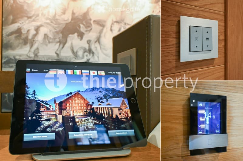 A modern room with a tablet displaying a welcome screen and a light switch panel on the wall.