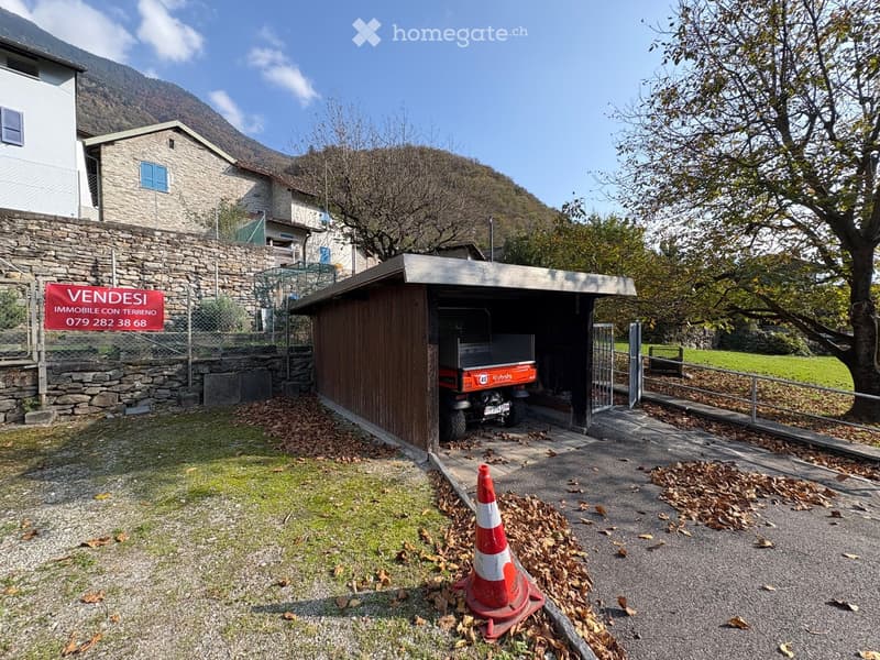 Property with garage, mountain view, surrounded by trees and buildings