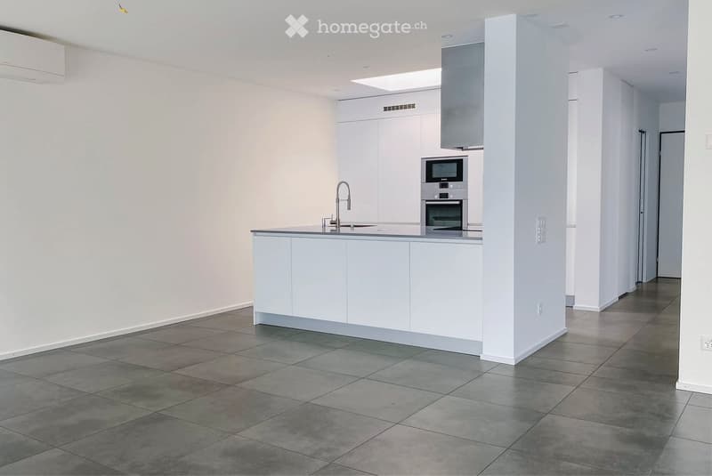 Modern kitchen with white cabinets, stainless steel appliances, and a central island with a sink and faucet.