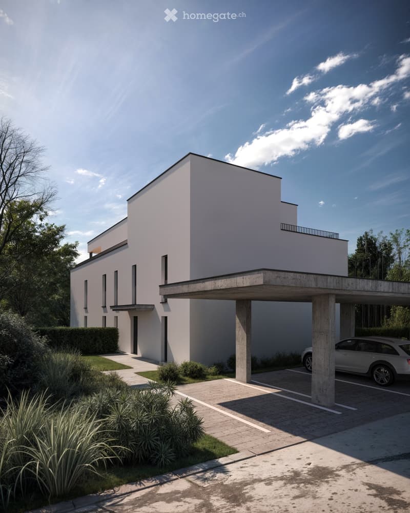 Modern two-story house with white exterior, flat roof, and covered parking area. Features include a raised ground floor, balcony, and landscaped garden with low hedges and plants.